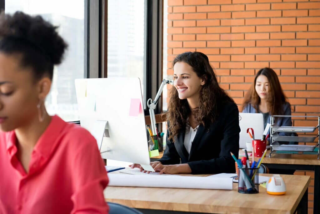happy business woman using computer her working desk office 1